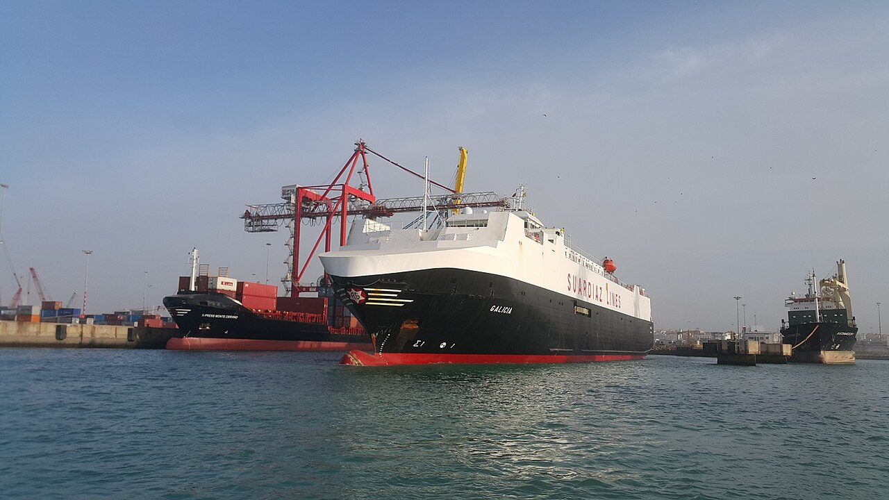 A roll-on/roll-off car carrier vessel berthed at a port, used to ship vehicles for export